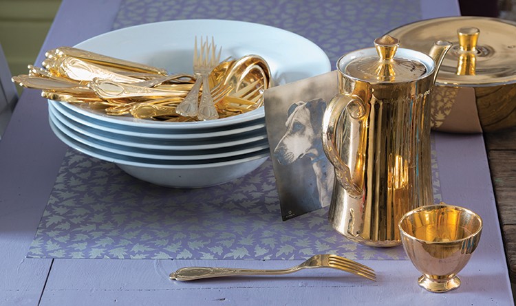Table styled with metallic kitchen accessories.